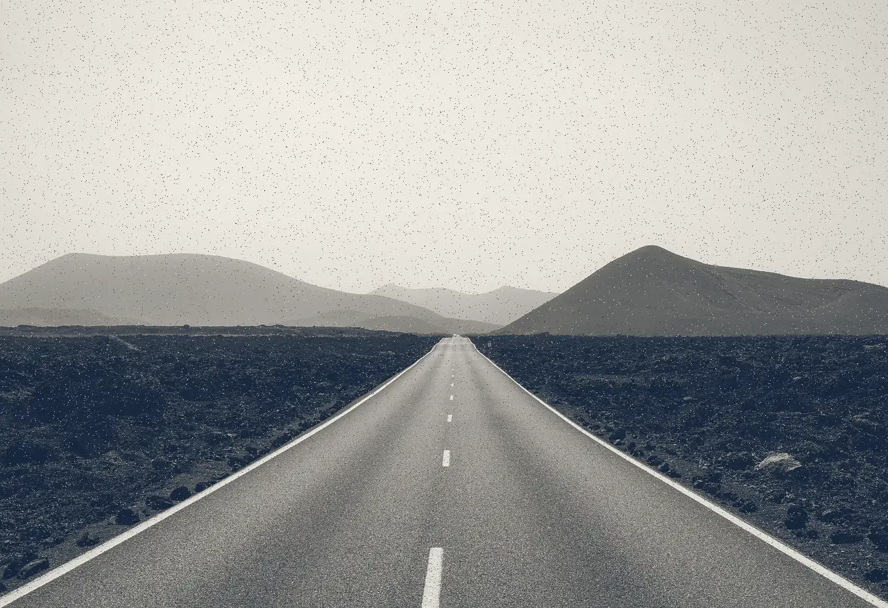 Straight road running toward distant hills